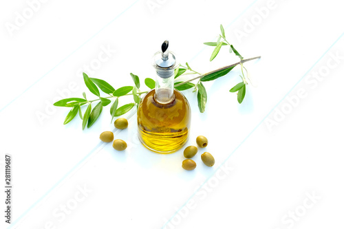 bottle of olive oil with olives and and an olive branch