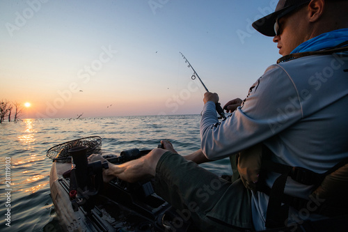 Obraz na płótnie Young Man Kayak Fishing at Sunrise in Canada w salonie