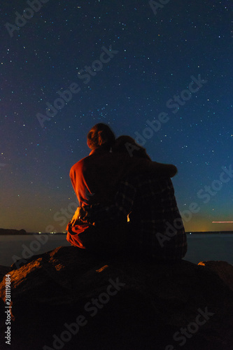 Lovely couple on the starry night sky background