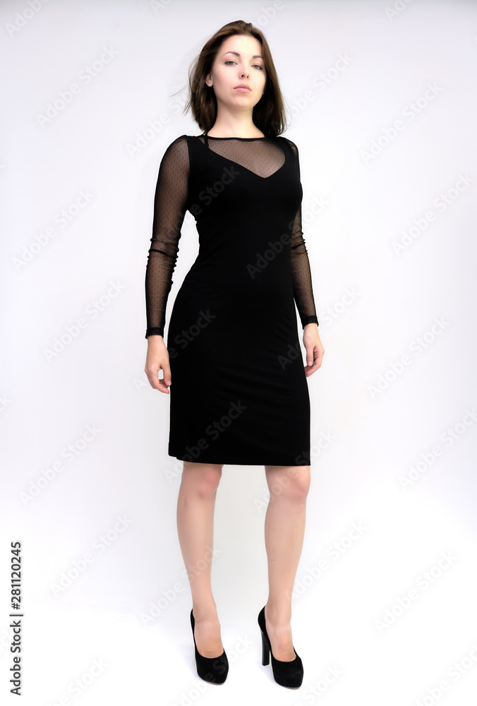 Horizontal Portrait of a pretty slim beautiful fashionable adult girl with beautiful brunette hair in a black dress. It should be in full growth, talking showing different poses and emotions Horizontal Portrait of a pretty slim beautiful fashionable adult girl with beautiful brunette hair in a black dress. It should be in full growth, talking showing different poses and emotions