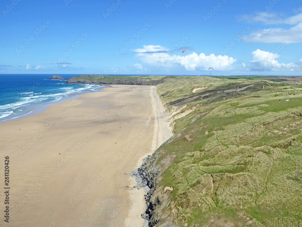 Paragliders above Perranporth Beach