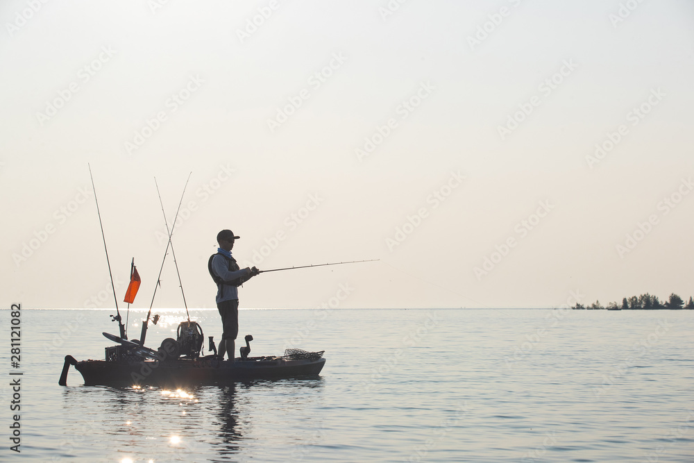 Young Man Kayak Fishing at Sunrise in Canada Young Man Kayak Fishing at Sunrise in Canada
