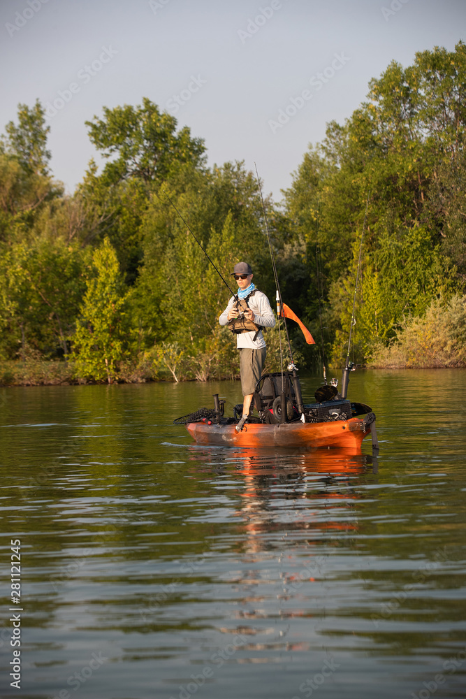 Young Man Kayak Fishing at Sunrise in Canada