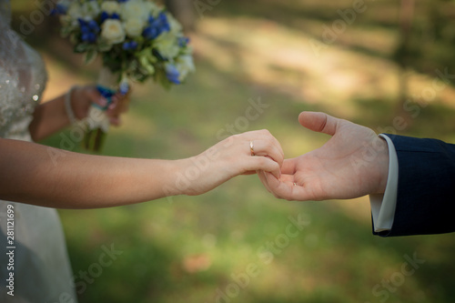 The bride and groom's hands with rings © Daniil