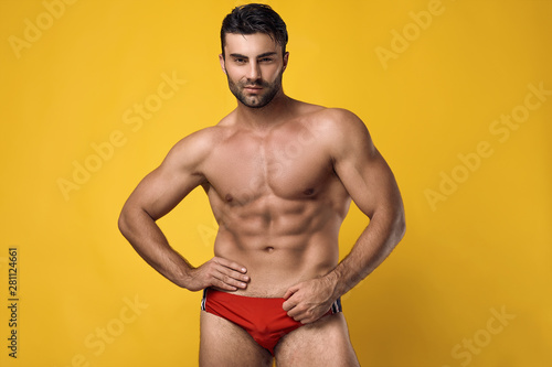 Beautiful brutal tanned muscular man wearing a red underwear