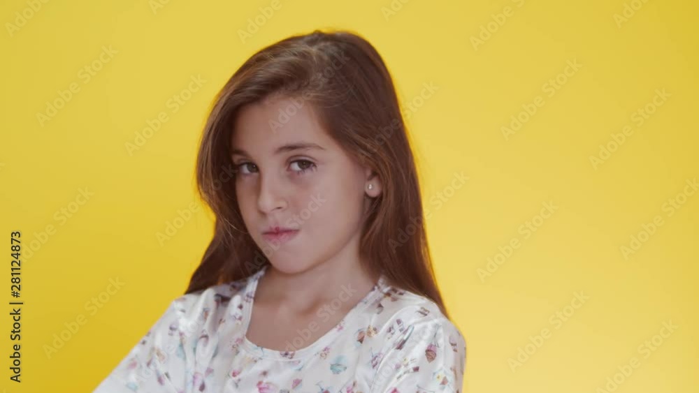 Child tantruming crossing the arms. On yellow background. Child tantruming crossing the arms. On yellow background.