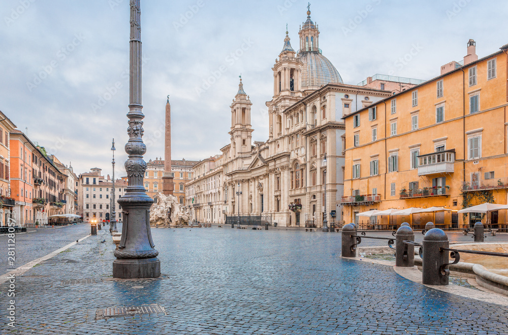 The northern end of the ancient Piazza Navona with the Sant'Agnese in Agone Baroque church & Fontana del Moro early in the morning with no people in the ancient capital city of Rome, Italy, Europe
