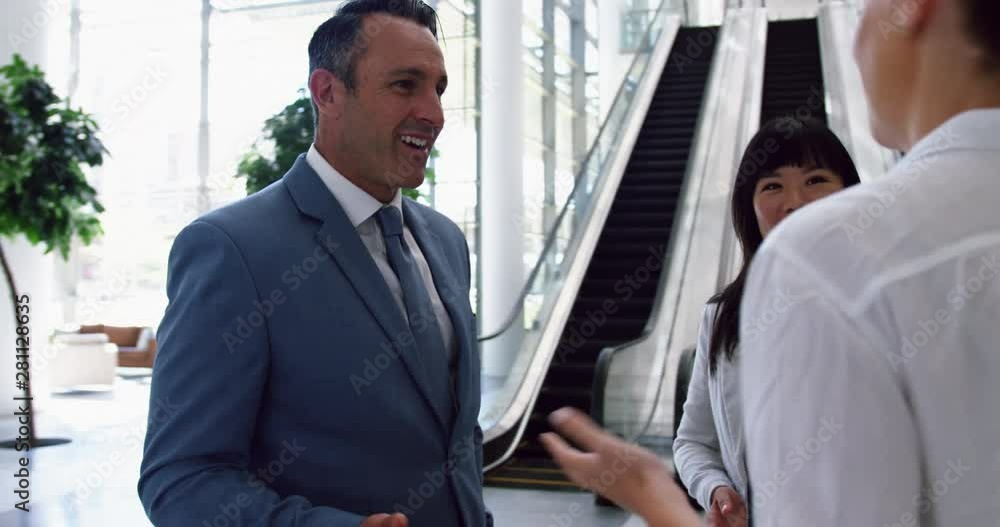 Business people interacting with each other in the lobby at office 4k Business people interacting with each other in the lobby at office 4k