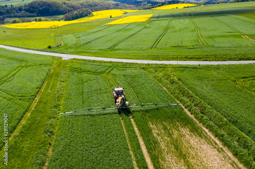 Aerial view  tractor sprays a field with fertilizer  Wetterau  Hesse  Germany