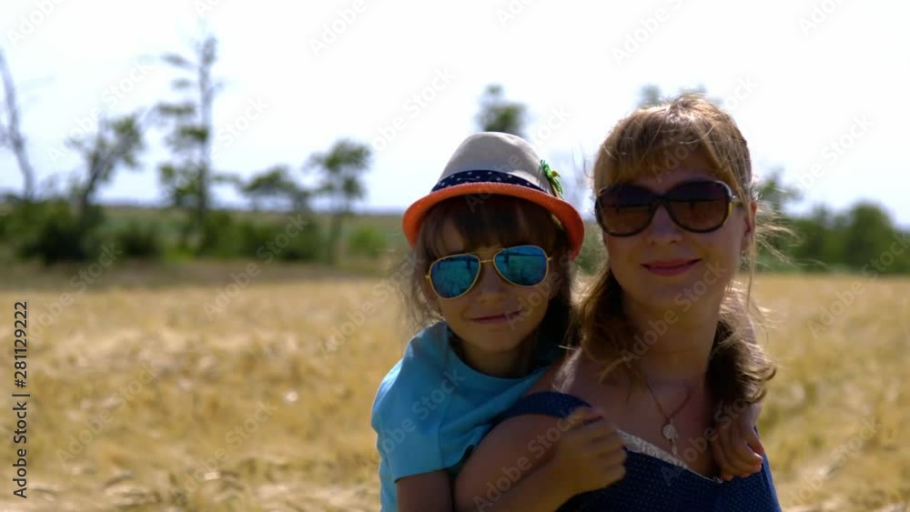 mother and daughter walk in a wheat field mother and daughter walk in a wheat field