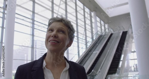 Wallpaper Mural Businesswoman looking upwards in the lobby at office 4k Torontodigital.ca