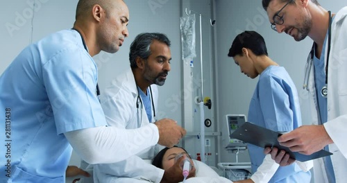 Group of doctors working together on a patient in hospital bed 4k photo