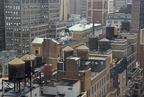 Photography Looking down at roofs with water tanks in New York City