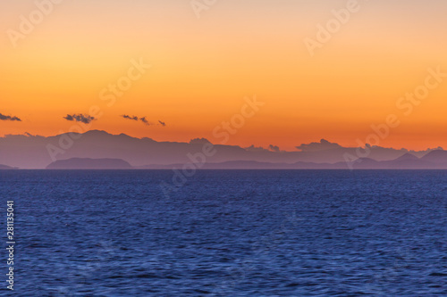 Beautiful sunset with orange sky with Aegean Sea islands background