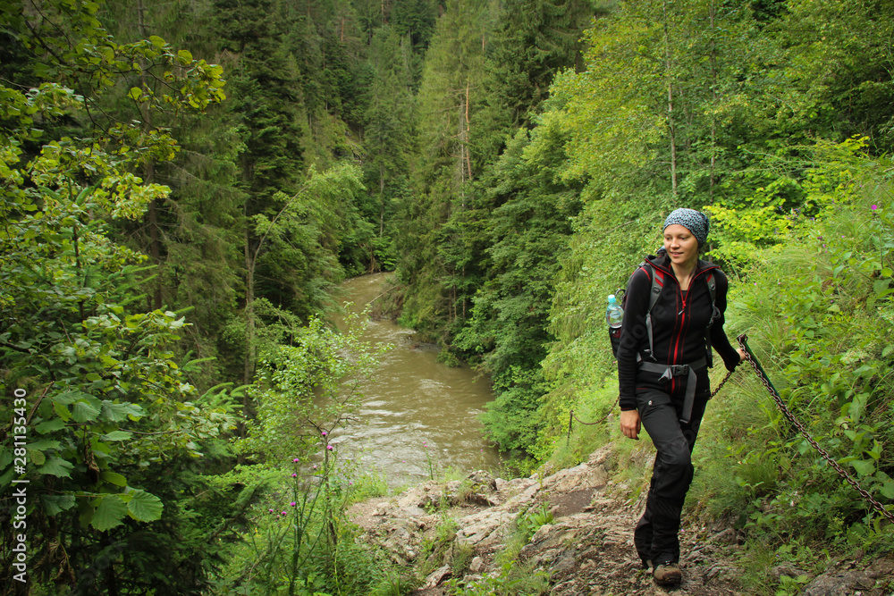 A tourist in the beautiful gorges of the Slovak Paradise National Park A tourist in the beautiful gorges of the Slovak Paradise National Park