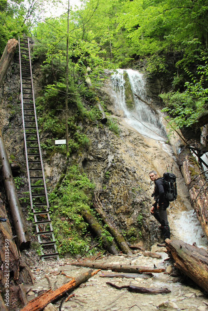 A tourist in the beautiful gorges of the Slovak Paradise National Park A tourist in the beautiful gorges of the Slovak Paradise National Park
