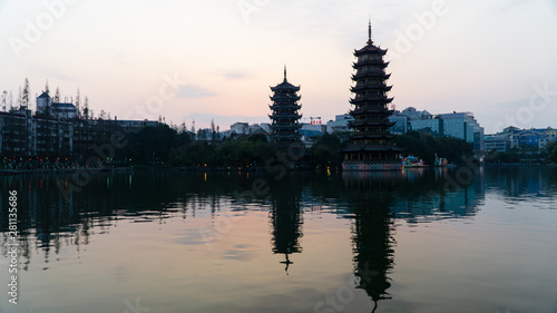 The Sun and Moon Twin Pagodas during sunset. View of Shanhu Lake (Fir Lake) in downtown of Guilin, China photo
