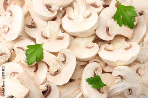Sliced mushrooms with parsley leaves as background texture. healthy food