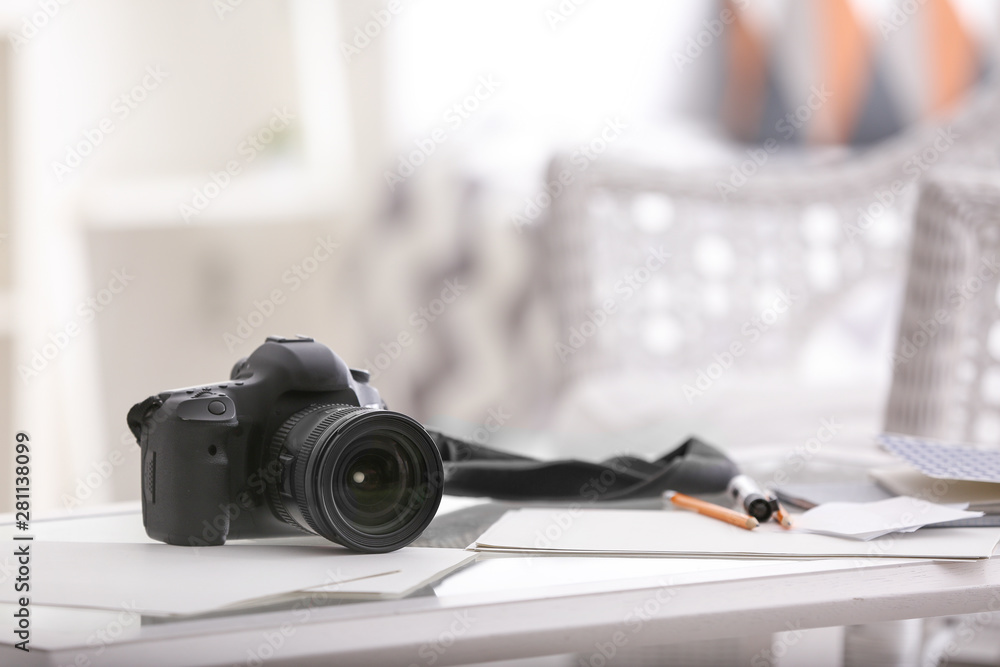 Modern photo camera on table in room Modern photo camera on table in room
