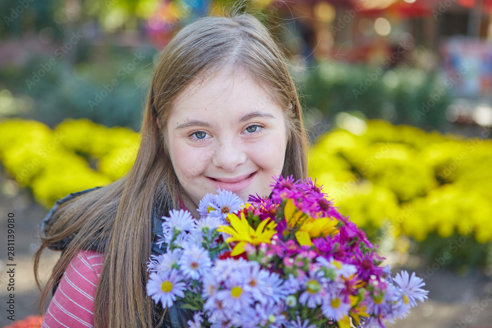 Girl with Down syndrome in autumn park. Girl with Down syndrome in autumn park.