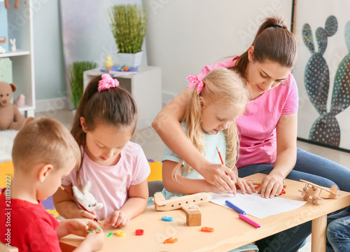 Nursery teacher with cute l...