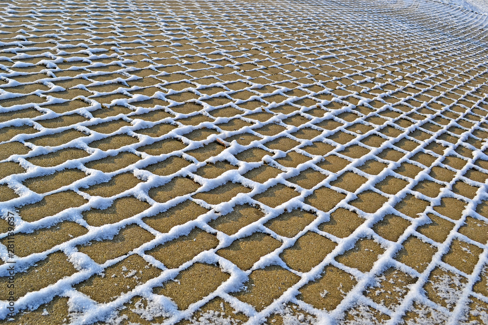 Fototapeta premium stone with grass lines under snow, winter season