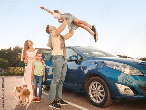 Happy family with dog near ...
