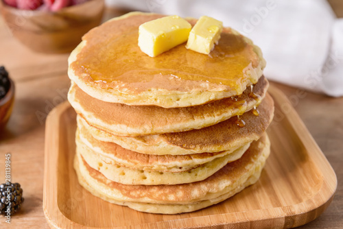 Tasty pancakes with butter on table