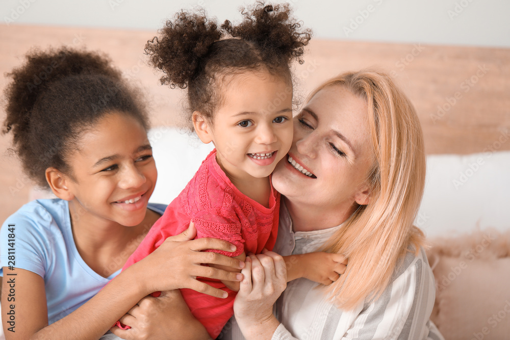 Happy woman with her African-American daughters at home Happy woman with her African-American daughters at home