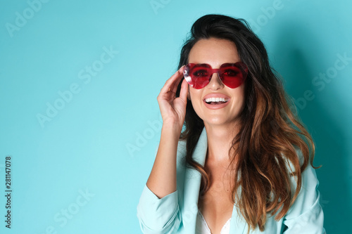 Portrait of smiling woman with heart shape sunglasses.