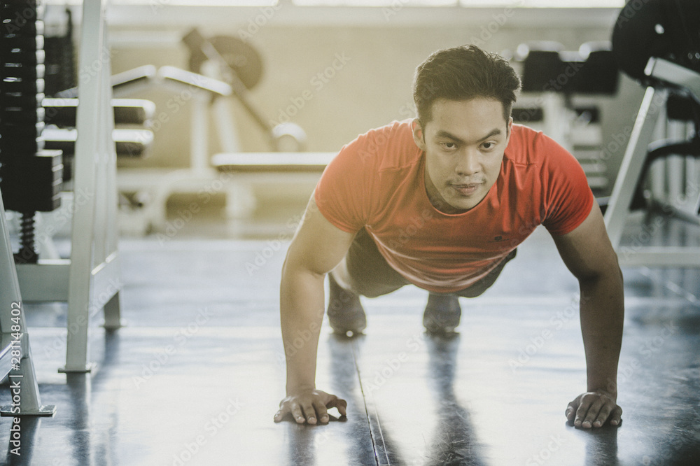 Portrait of Asian man being physically Push-up in the gym. Portrait of Asian man being physically Push-up in the gym.