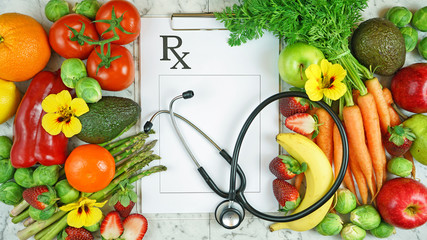 Healthy lifestyle, food is medicine, prescription for good health concept flatlay with colorful fruits and vegetables and clipboard.