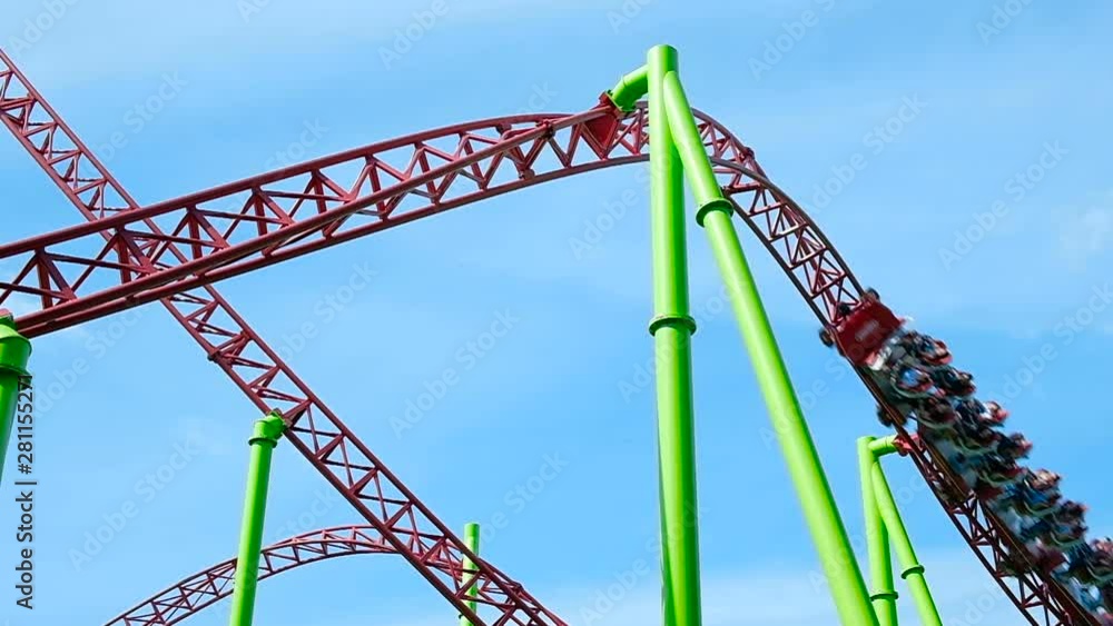 people drive along red roller coaster rails with spinning people drive along red roller coaster rails with spinning