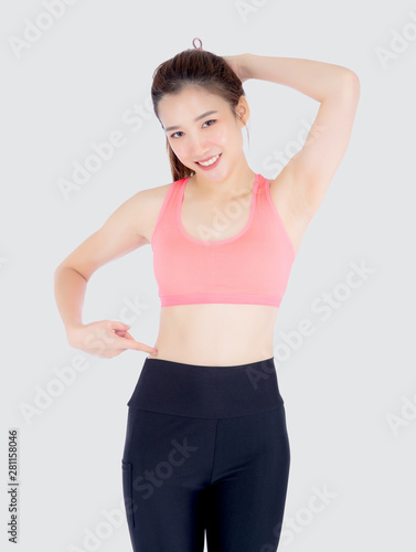 beautiful portrait young asian woman in sport clothing pointing waist with satisfied and confident isolated on white background, girl have shape and wellness, exercise for fit with health concept. © N_studio