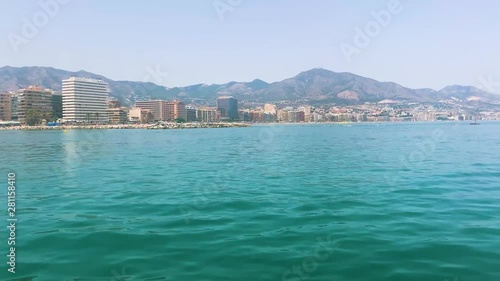 A stunning view of the coastline of Fuengirola on the Costa Del Sol  from the sea. Neighbouring towns can be seen in the distance framed by the majestic Spanish Mountains.