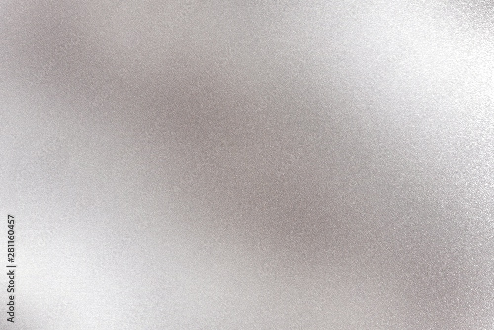 Glowing silver metallic panel with scratched surface, abstract texture background Glowing silver metallic panel with scratched surface, abstract texture background