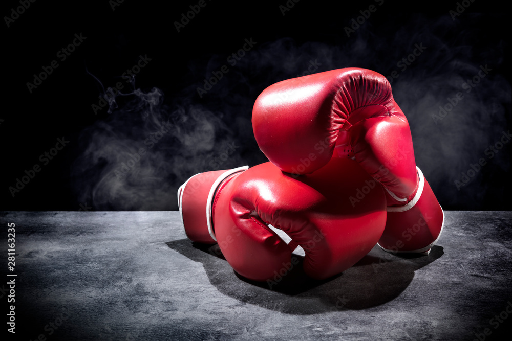 Pair of red boxing gloves on the table