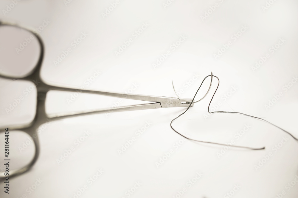 Medical instruments Surgical suture with Forceps on white background. - Image Medical instruments Surgical suture with Forceps on white background. - Image
