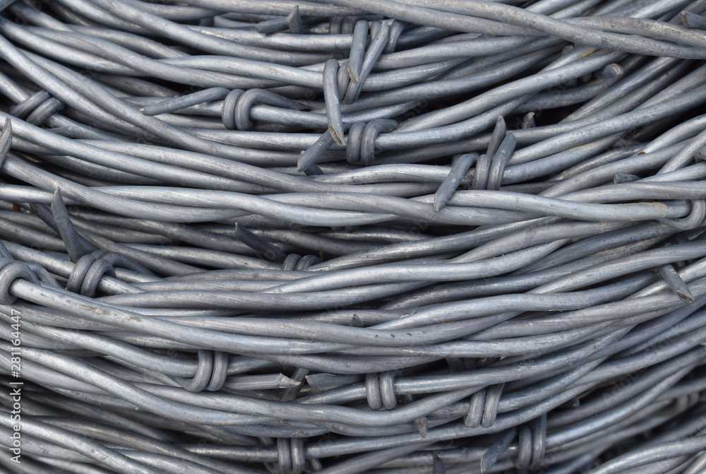 Coil, roll of barbed wire, fencing, background Coil, roll of barbed wire, fencing, background