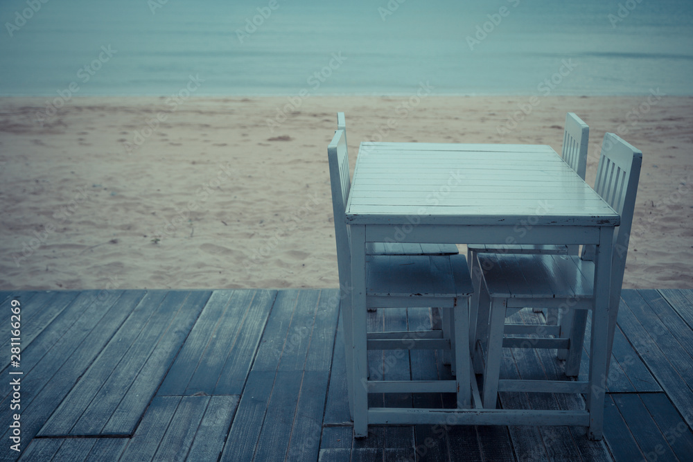 Vintage tone of White table for dinner on the beach and sky