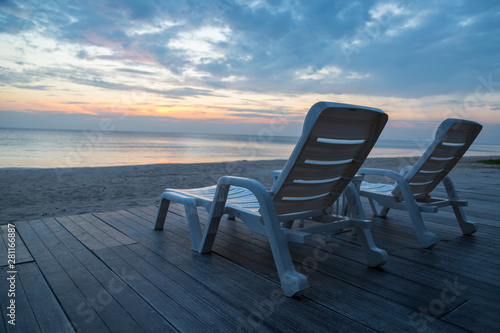 White chairs on the beach before sunset background