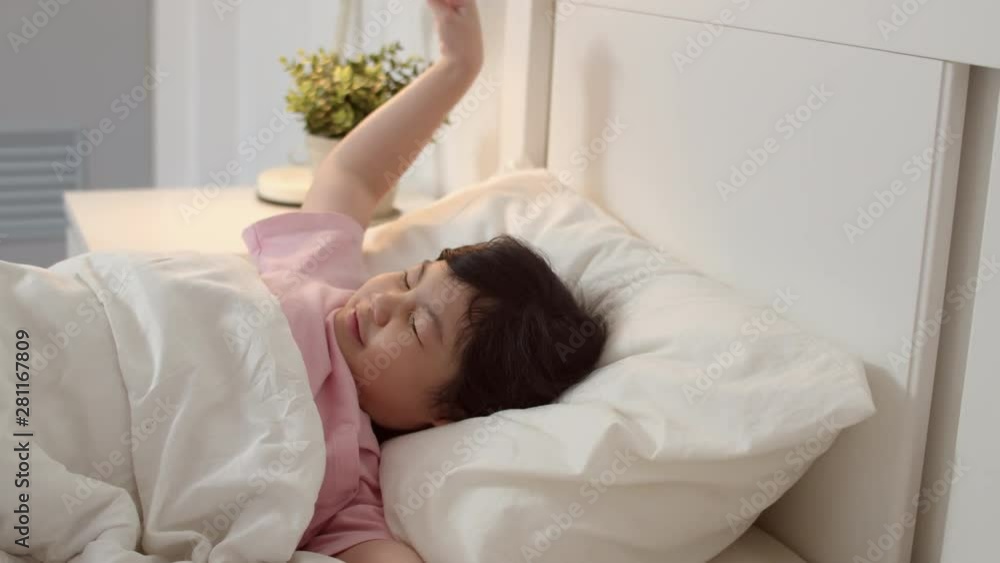 Young Asian girl wake up at home. Asia japanese woman child kid relax rest after sleep all night lying on bed, feel comfort and calm in bedroom at home in the morning concept. Slow motion shot. Young Asian girl wake up at home. Asia japanese woman child kid relax rest after sleep all night lying on bed, feel comfort and calm in bedroom at home in the morning concept. Slow motion shot.