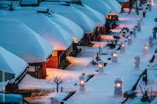 Light up illumination with thatched roof house,  village made of over 30 traditional Japanese houses  and snow covered street in Ouchi Juku village, Fukushima, Tohoku, Japan in Winter photo