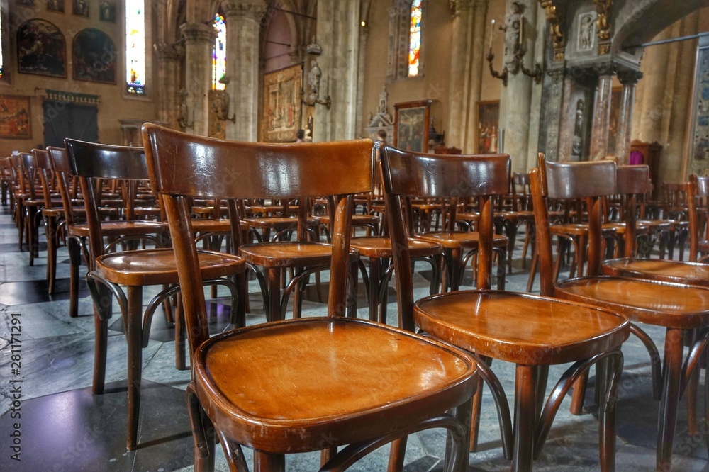 Chairs for believers in the old Cathedral of Como