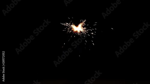 Slowed down video of burning sparkler in dark. Fiery bengal light on black background in 4k ultrahd (UHD) 3840x2160