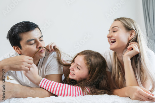 Portrait happy family spending time together on bed in bedroom. family and home concept 