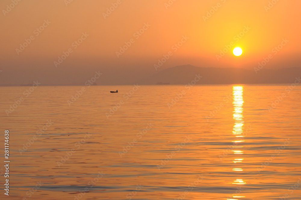A Boat in the Morning Sea