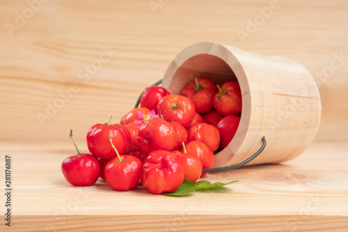 Obraz na plátně Acerola cherry in wooden bucket on wooden background