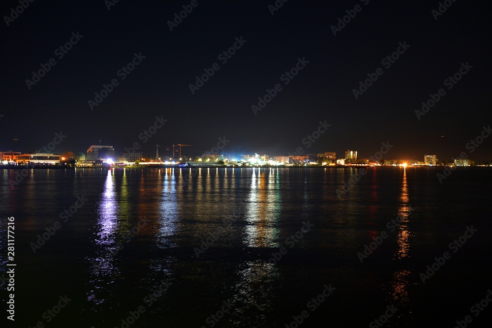 the city lights reflected in the water at night