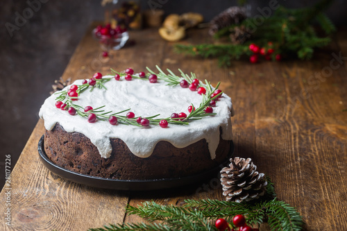 Quadro su tela Traditional Christmas cake with fruits, nuts and white glaze with Christmas deco